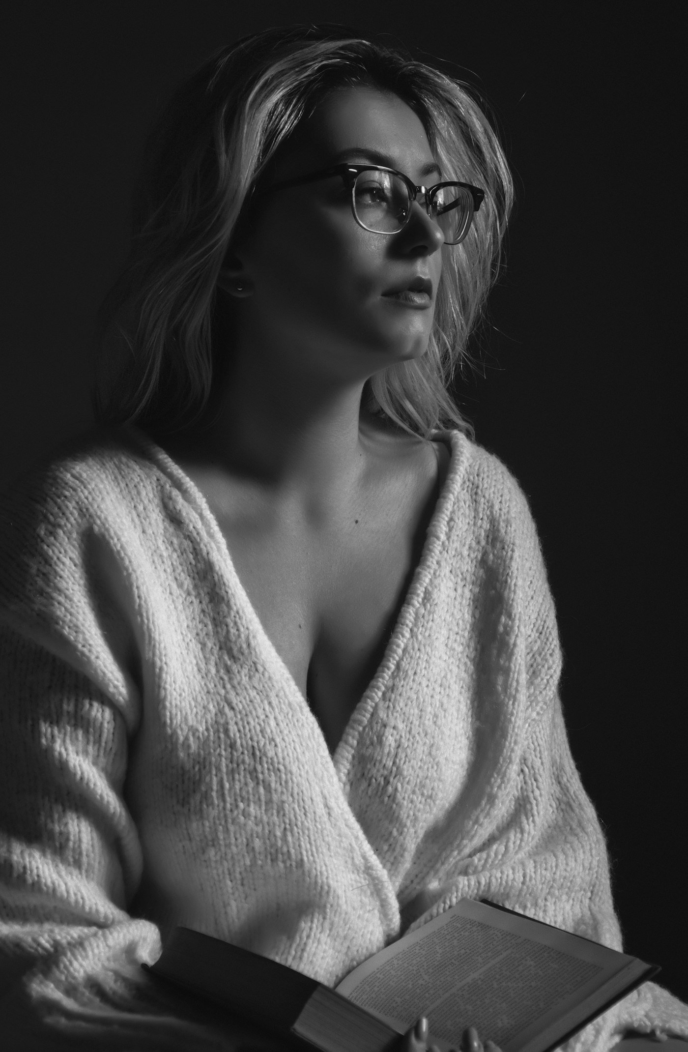 Woman in a knit sweater wearing black sunglasses