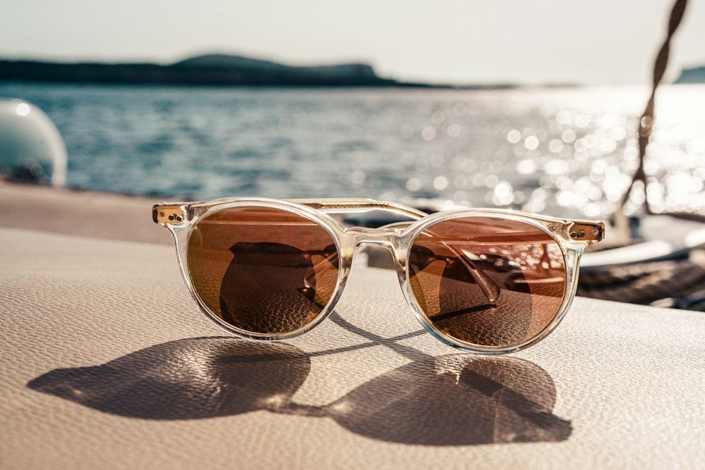 White-framed sunglasses with brown lenses